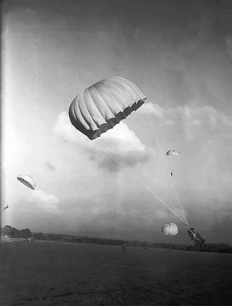 Parachutists in descent and coming to land, during WW2