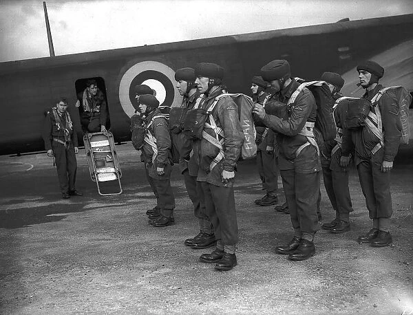 Parachutists during WW2, kitted up for exercise and ready to board plane. Circa 1942