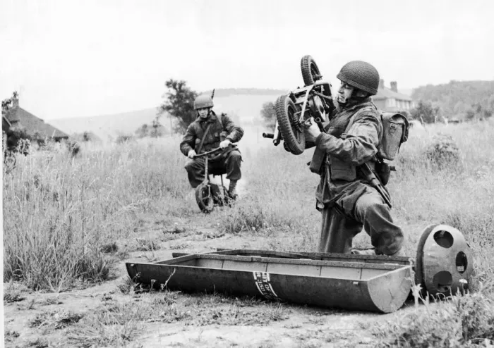 Framed Print : Paratrooper assembles his folding motor scooter - a. k. a Framed Print : Paratrooper assembles his folding motor scooter - a. k. a