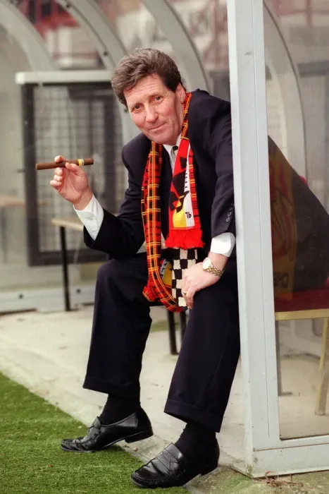 Framed Print : Partick Thistle football manager John Lambie smoking a cigar as he sits in the dugout Framed Print : Partick Thistle football manager John Lambie smoking a cigar as he sits in the dugout