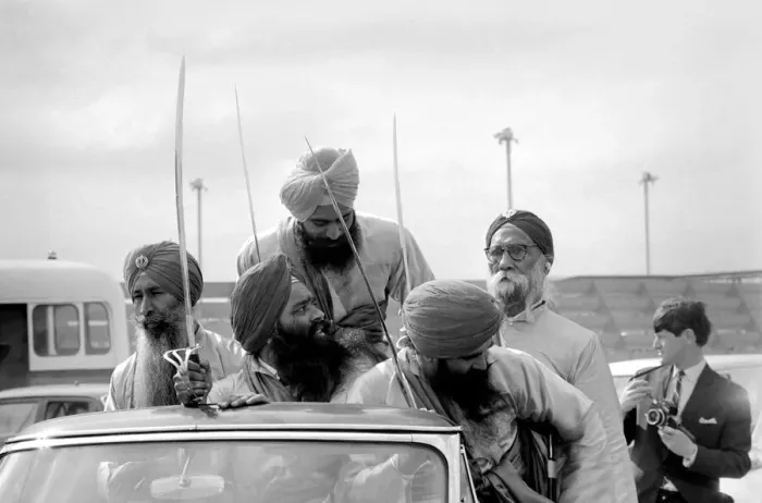 Framed Print : A party of Sikhs drive around the tarmac at Heathrow airport with Sikh Framed Print : A party of Sikhs drive around the tarmac at Heathrow airport with Sikh