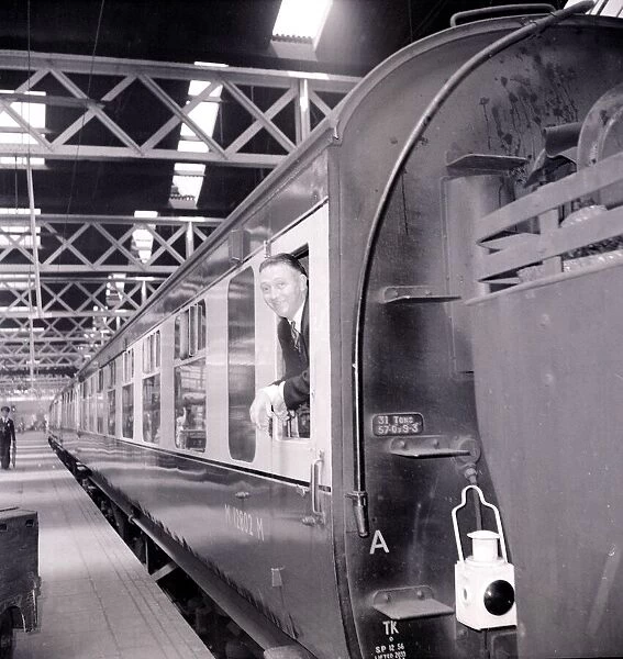 A passenger awaits the depature of his train from Euston Station July 1955