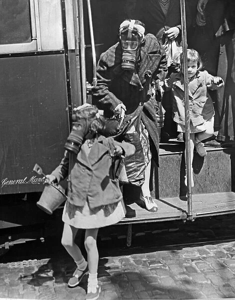 Passengers disembark from a bus wearing their gas masks during an ARP exercise