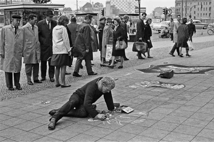 Framed Print : Passers by stop and admire the work of a street artist, who uses the pavements of