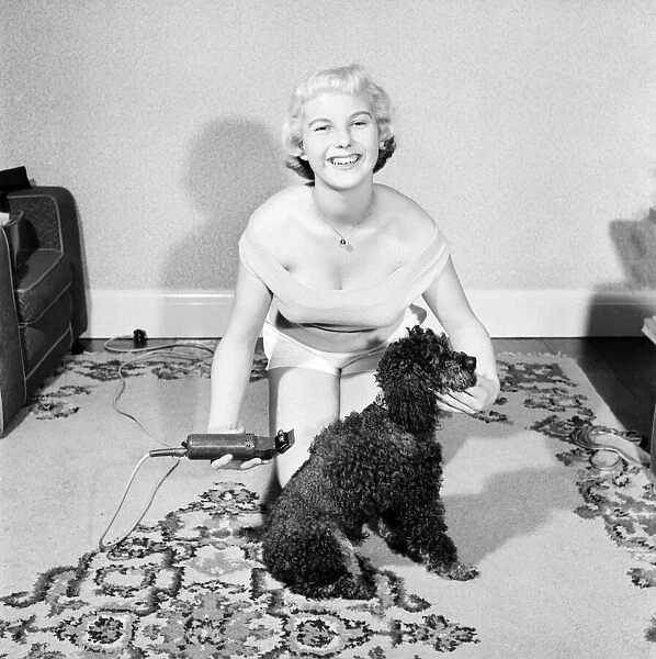 Pat Bolton seen here with her pet poodle dog. 1964 E298-010