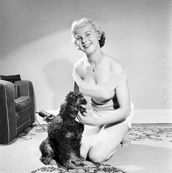 Pat Bolton seen here with her pet poodle dog. 1964 E298-011