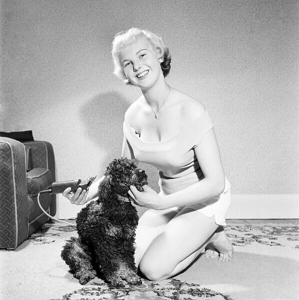 Pat Bolton seen here with her pet poodle dog. 1964 E298-012