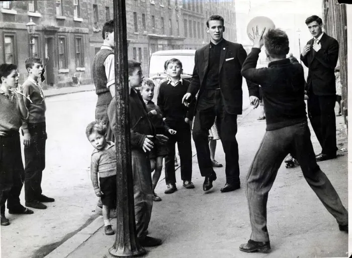 Framed Print : Pat Crerand 1960 with Charlie Gallagher And Kids playing football in street