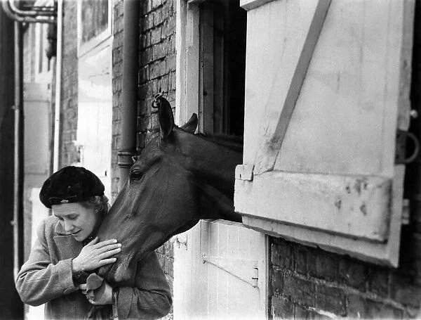A pat and a lump of sugar for Arkle from his owner the Duchess of Westminster at Kempton
