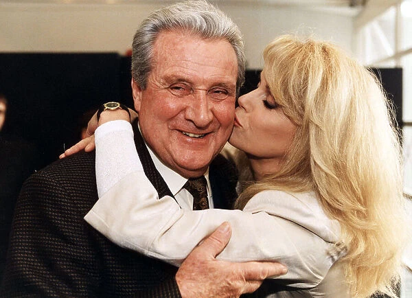 PATRICK MACNEE BEING KISSED BY JOANNA LUMLEY AT THE NEW AVENGERS PHOTO CALL