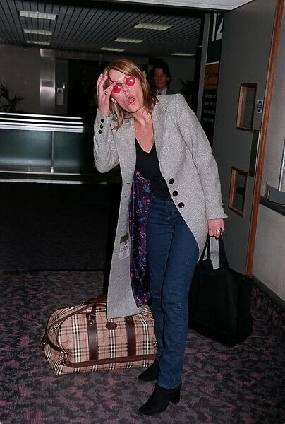 Patsy Kensit Actress June 98 Leaving heathrow airport for los angeles holding big