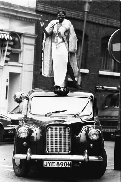 Patti Boulaye singer Standing on top of a taxi celebrating after winning Singer of
