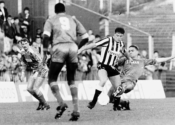 Paul Gascoigne of Newcastle United challenged for the ball by Vinnie Jones of Wimbledon