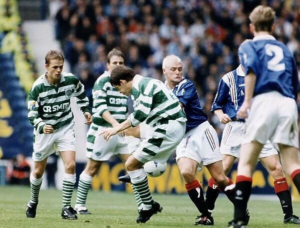 Paul Gascoigne of Rangers challenges Tosh McKinlay of Celtic in the Scottish Premier