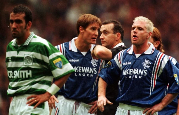 Paul Gascoigne of Rangers makes a face at Paolo di Canio of Celtic with Richard Gough