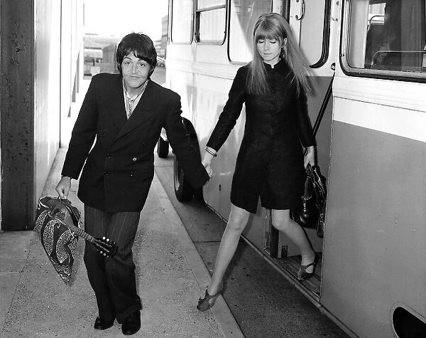 Paul McCartney of the Beatles and girlfriend Jane Asher get off the bus at their stop