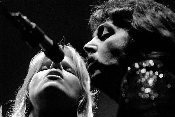 Paul McCartney, formerly of The Beatles, singing with his wife Linda as part of their