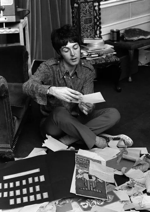Framed Print : Paul McCartney of The Beatles sitting on the floor cross legged as he opens up birthday Framed Print : Paul McCartney of The Beatles sitting on the floor cross legged as he opens up birthday