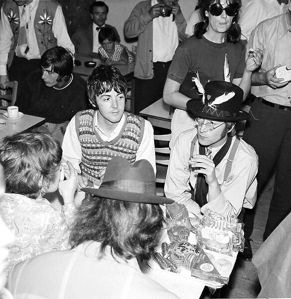 Paul McCartney, George Harrison (back to camera) and John Lennon