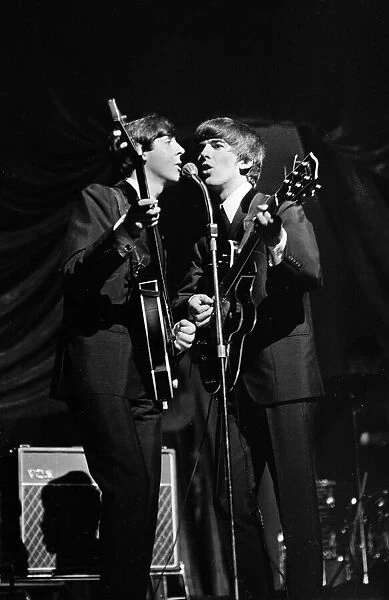 Paul McCartney and George Harrison of The Beatles performing on stage in Carlisle
