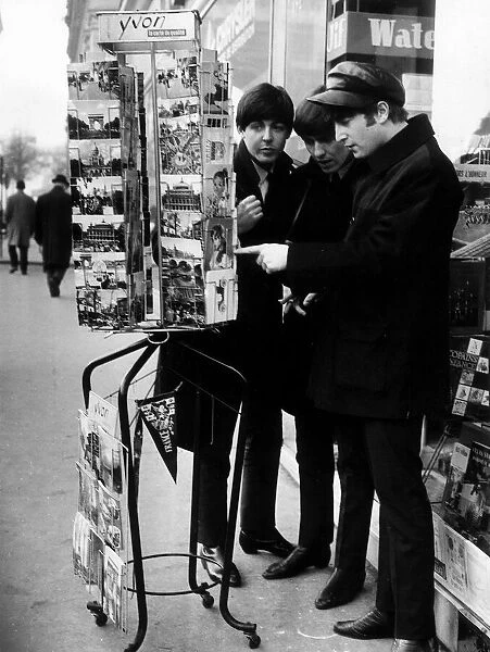 Paul McCartney, George Harrison and John Lennon of the Beatles pop group looking at