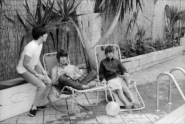 Paul McCartney, George Harrison and Ringo Starr relax on sun loungers at their rented