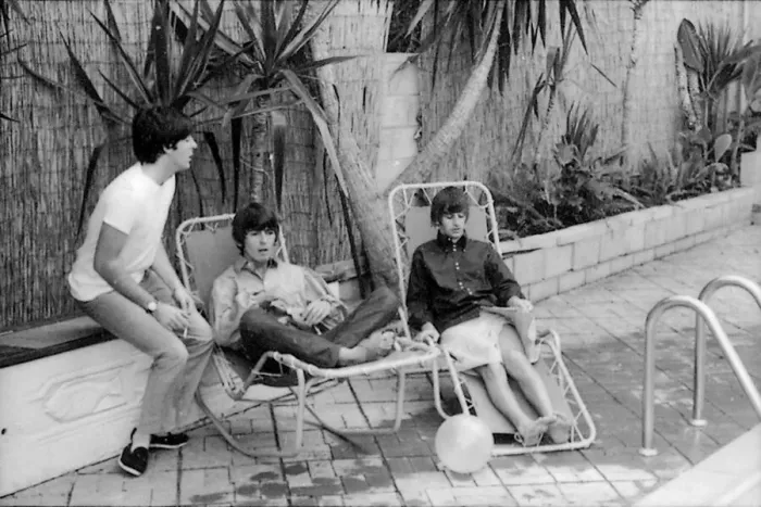 Framed Print : Paul McCartney, George Harrison and Ringo Starr relax on sun loungers at their rented