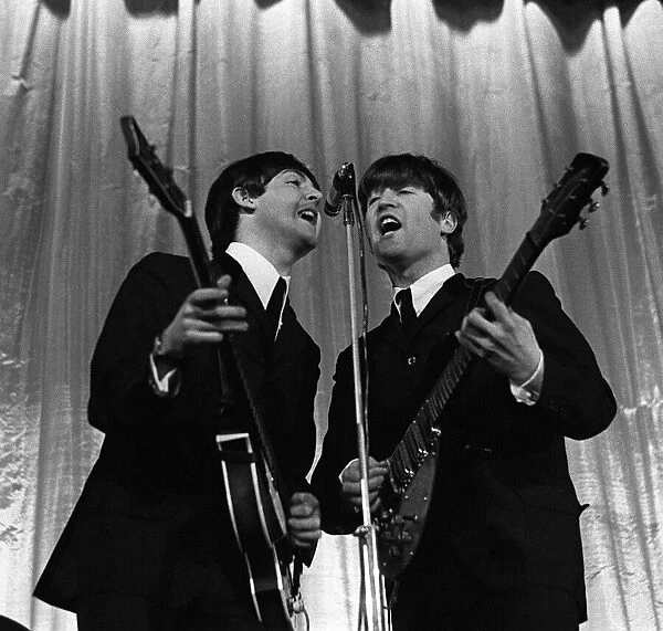 Paul McCartney & John Lennon of The Beatles perform on stage November 1964