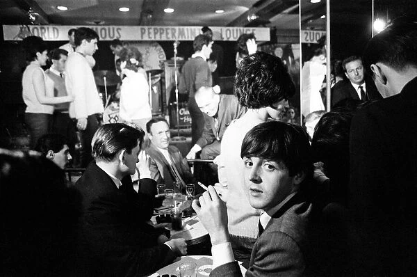 Paul McCartney (seated looking round to the camera) of The Beatles, New York, USA