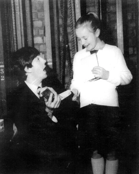 Paul McCartney signs an autograph for nine year old Caroline Helme from Tile Hill