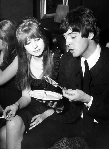 Paul McCartney Singer and guitar player with the Beatles sits with Jane Asher, circa 1964