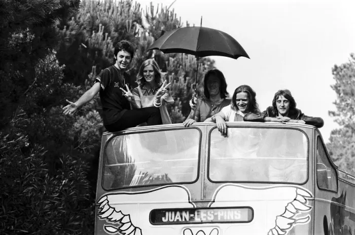 Framed Print : Paul McCartney and his wife Linda in Paris, France, with other members of the group Wings
