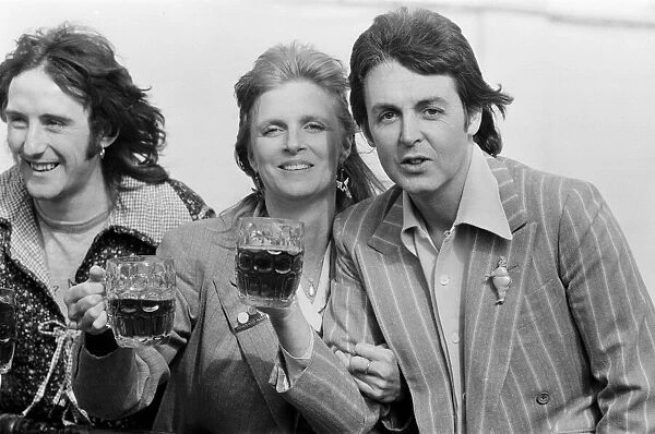Paul McCartney and his wife Linda of pop group Wings enjoy a pint of ale as they make a
