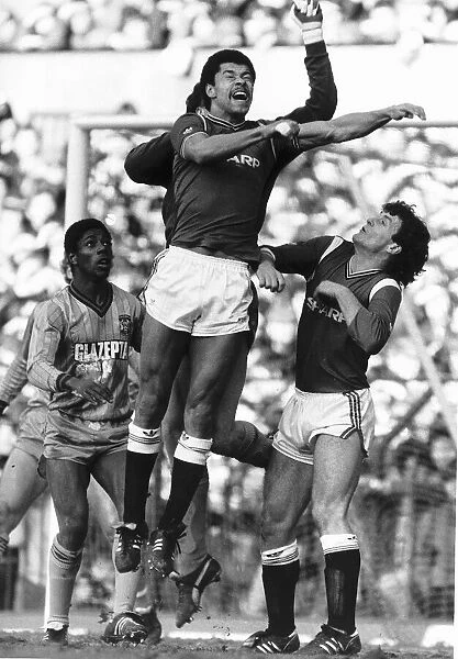 Paul McGrath of Manchester United jumps up for a high ball during his side