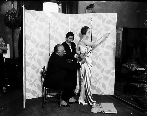 Paul Poiret designing a gown on one of his Mannequins October 1924