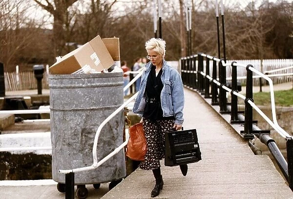 Paula Yates TV Presenter Walking over bridge with holding typewriter