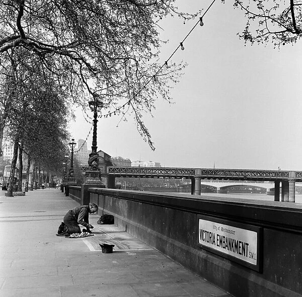 Pavement Artist at work on the Embankment, London. Circa 1945