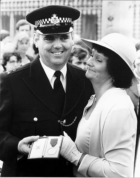 PC Trevor Lock with his wife Doreen outside Buckingham Palace after being presented with