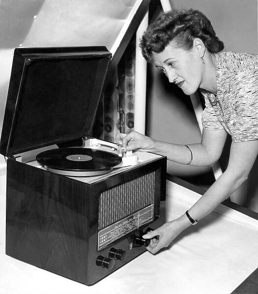 Peggy Kingston of Chiswick with a Philips minature table radiogram, TBIS 5 Valve Model