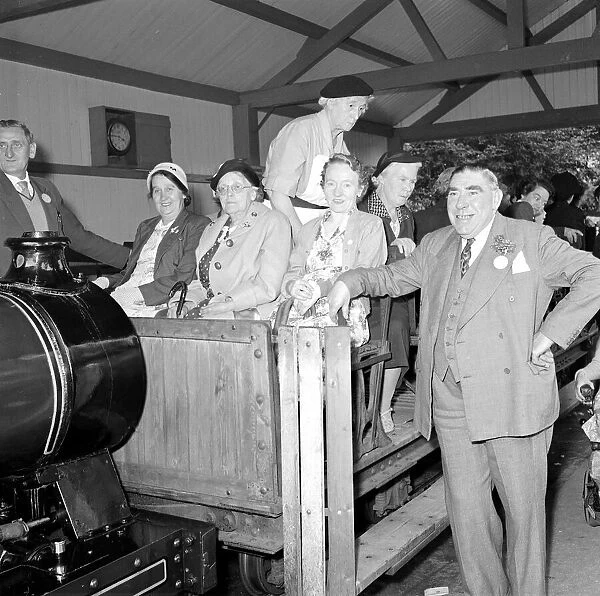 Pensioners on a day trip to Trentham Park prepare for a tour of the park on a model