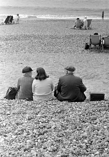 Pensioners sitting on the pebble beach at Brighton July 1958