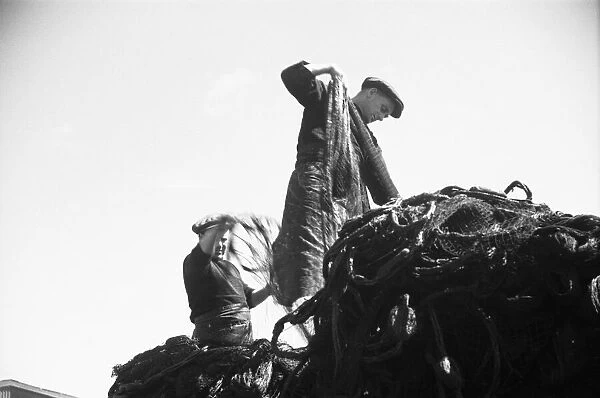 Penzance fishermen seen here preparing their nets before going to sea. July 1939