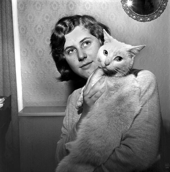 People with Animals: A Woman holding up her pet cat. November 1969 Z10902
