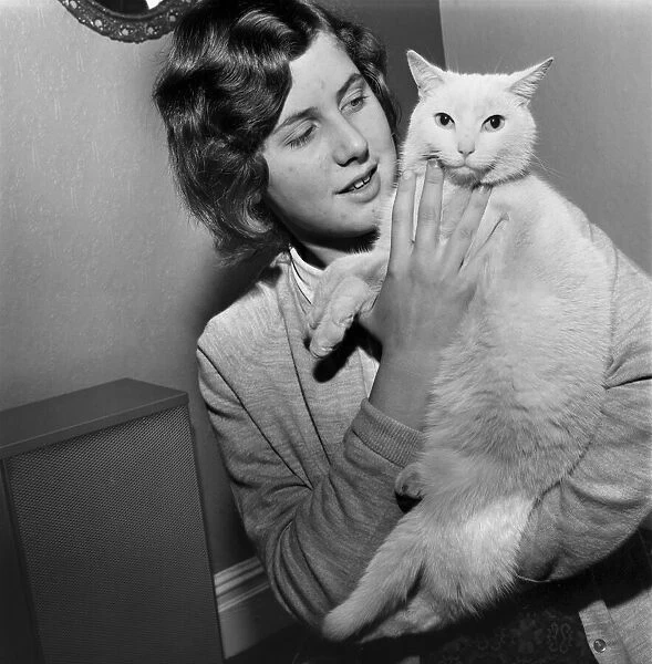 People with Animals: A Woman holding up her pet cat. November 1969 Z10902-001