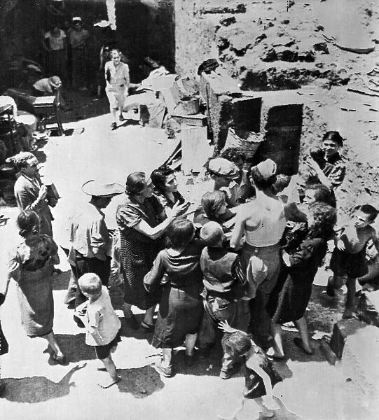 People of Catania, Sicily scramble for food given out by men of the Royal Air Force