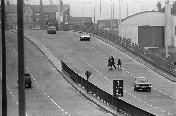People crossing the motorway dangerously, in the north of England. 8th November 1974