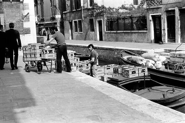 People: Culture: General scenes in Venice. Beer being delivery to a canal side cafe