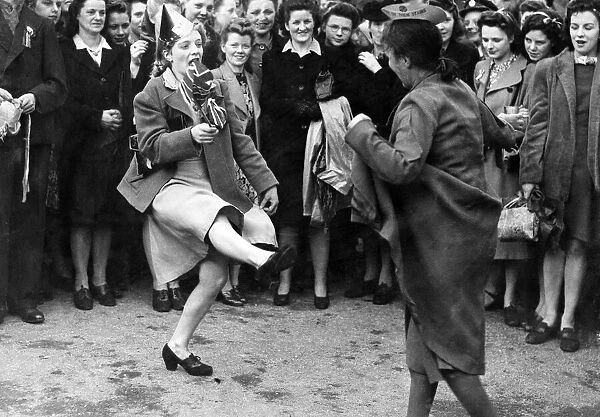 People dancing in the street on VE Day in Piccadilly Gardens, Manchester. 8th May 1945