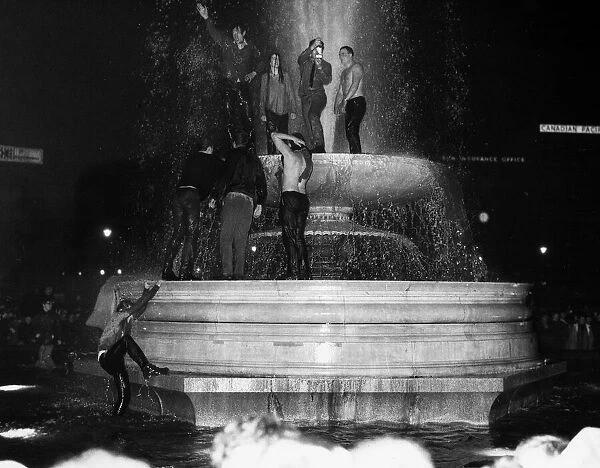 People dancing around in the Trafalgar Square Fountain - Jan 1969