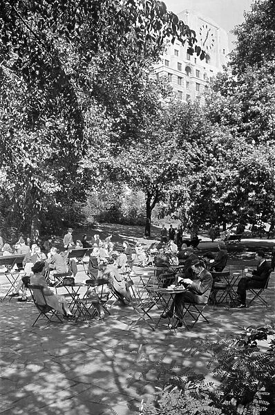 People enjoying afternoon tea in Victoria Gardens on the Embankment, London